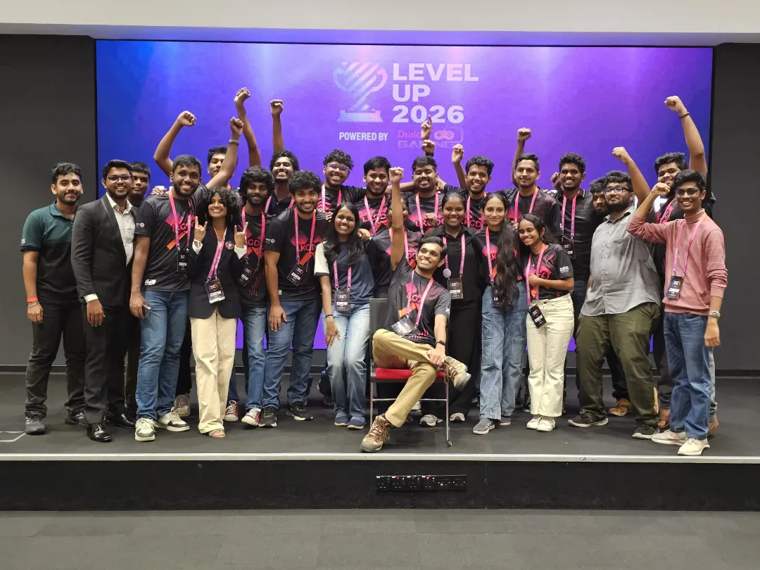 The LKGDC 2026 organizing team cheering on stage in front of the Level Up 2026 screen